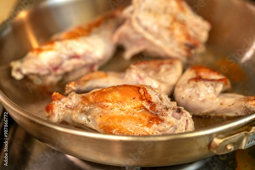 Obraz na płótnie Portions of rabbit meat are fried in a frying pan closeup w salonie