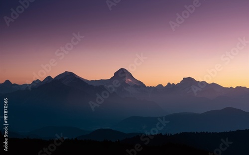 A distant mountain range silhouetted against a vibrant sunset sky.