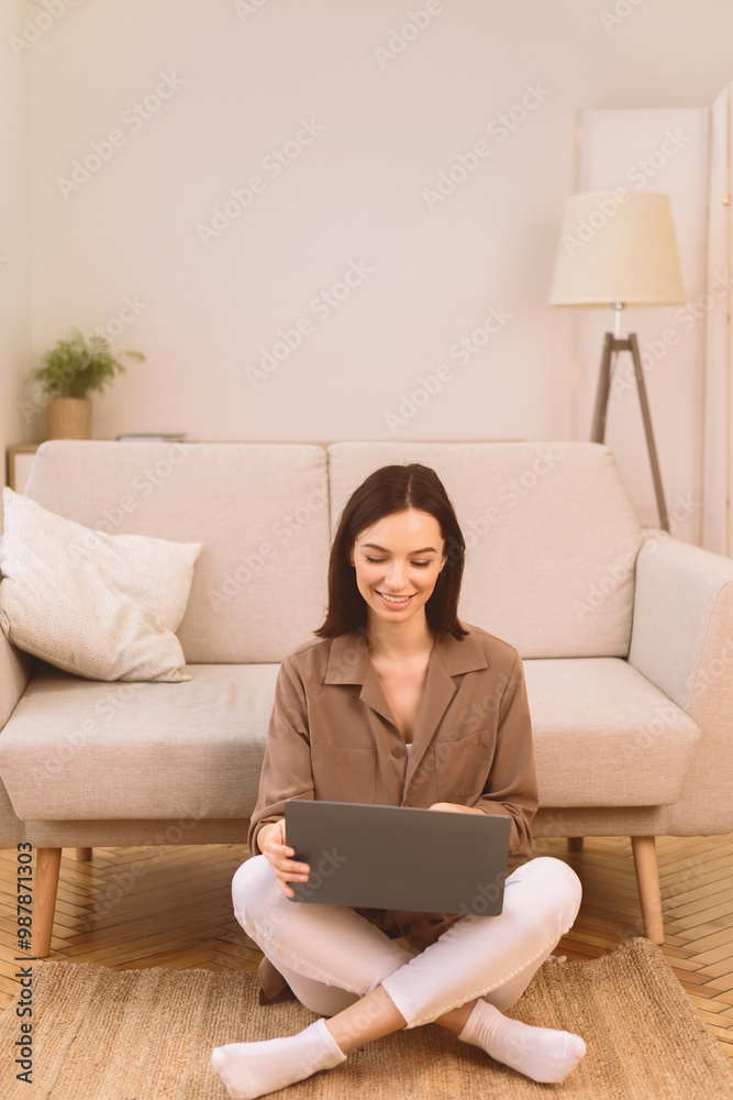Surfing Internet. Happy smiling woman working on laptop computer, sitting on the floor with legs crossed, copyspace Surfing Internet. Happy smiling woman working on laptop computer, sitting on the floor with legs crossed, copyspace