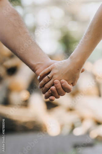 Bride and groom, newlyweds in love holding hands outdoors. Wedding photography.