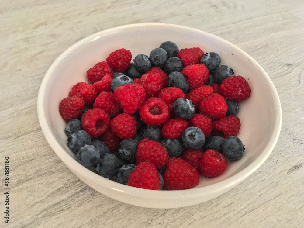 Close-up tasty ripe fresh summer berries - raspberry and blueberry Close-up tasty ripe fresh summer berries - raspberry and blueberry