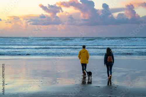 couple walking at sunset in the autumn in the beach in basque country