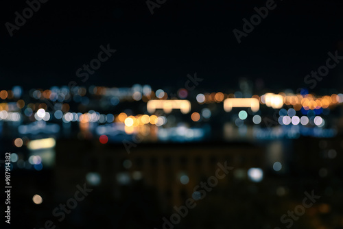 Defocused night city view with lights on black background