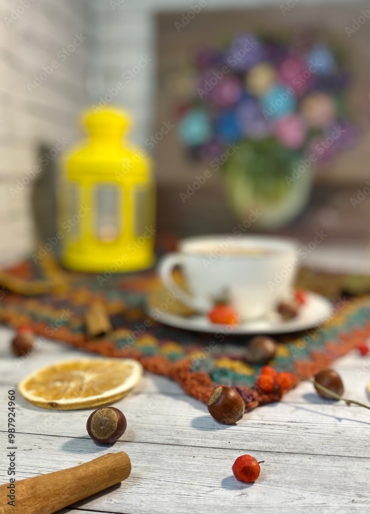 Cozy autumn photo with a cup of tea, flashlight, knitting, leaves and decor