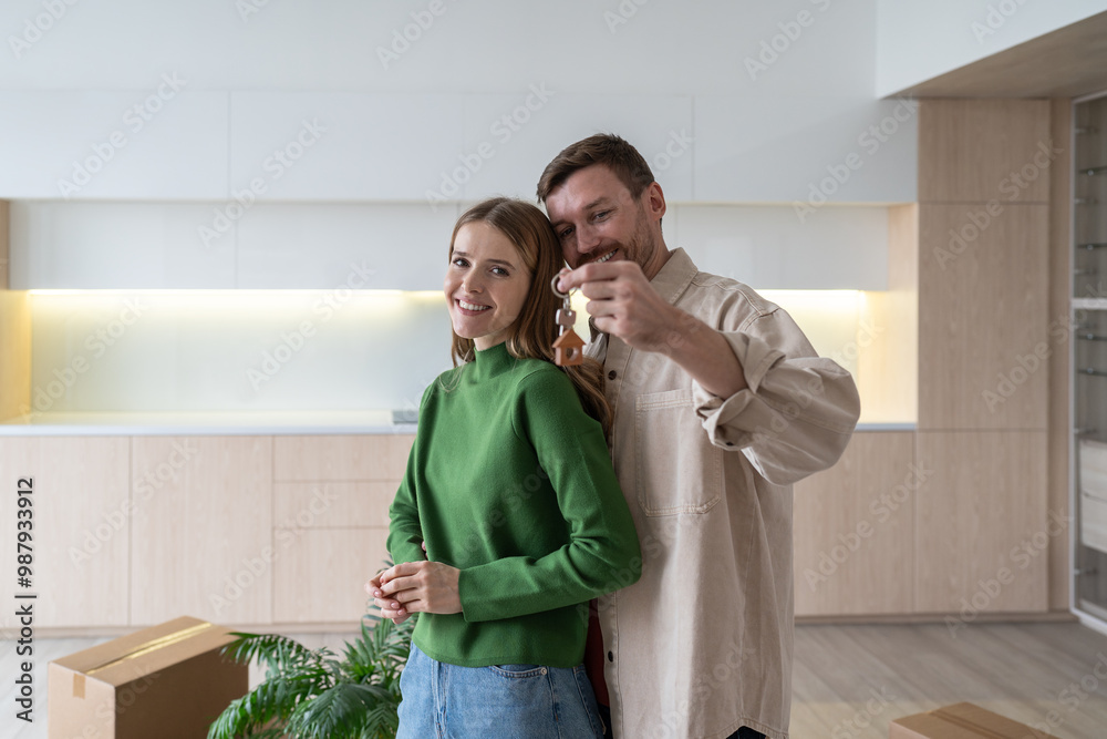 Joyful family embraces, holding keys to new apartment post move. Romantic couple purchased apartment, family relocation, mortgage loan, rental investment, homeownership, new construction investment Joyful family embraces, holding keys to new apartment post move. Romantic couple purchased apartment, family relocation, mortgage loan, rental investment, homeownership, new construction investment