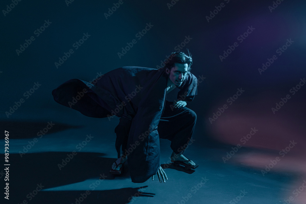 Fototapeta premium A guy in a kimono and geta in the image of a charismatic villain, dynamic poses, wide-angle view