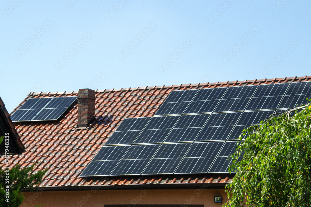 Solar power energy on the roof to a standard house. Solar power panels ,Photovoltaic modules for innovation green energy for life with blue sky background. High quality photo Solar power energy on the roof to a standard house. Solar power panels ,Photovoltaic modules for innovation green energy for life with blue sky background. High quality photo