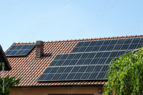 Solar power energy on the roof to a standard house. Solar power panels ,Photovoltaic modules for innovation green energy for life with blue sky background. High quality photo