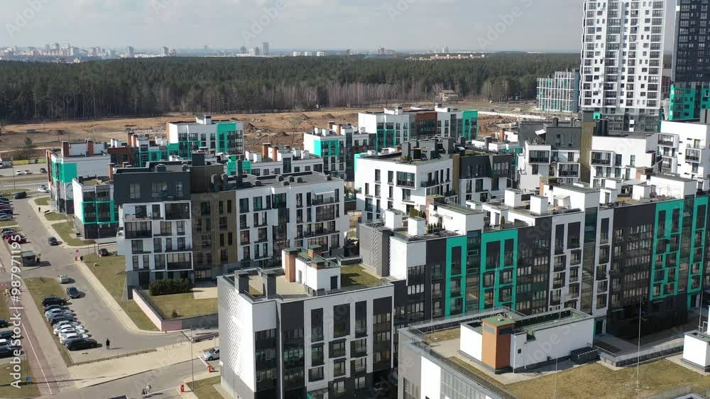 New buildings outside of a huge metropolis. Modern multi-storey housing near the forest. Suburbs of the city, satellite town. A city near a forest. Architecture, design of modern high-rise buildings. New buildings outside of a huge metropolis. Modern multi-storey housing near the forest. Suburbs of the city, satellite town. A city near a forest. Architecture, design of modern high-rise buildings.