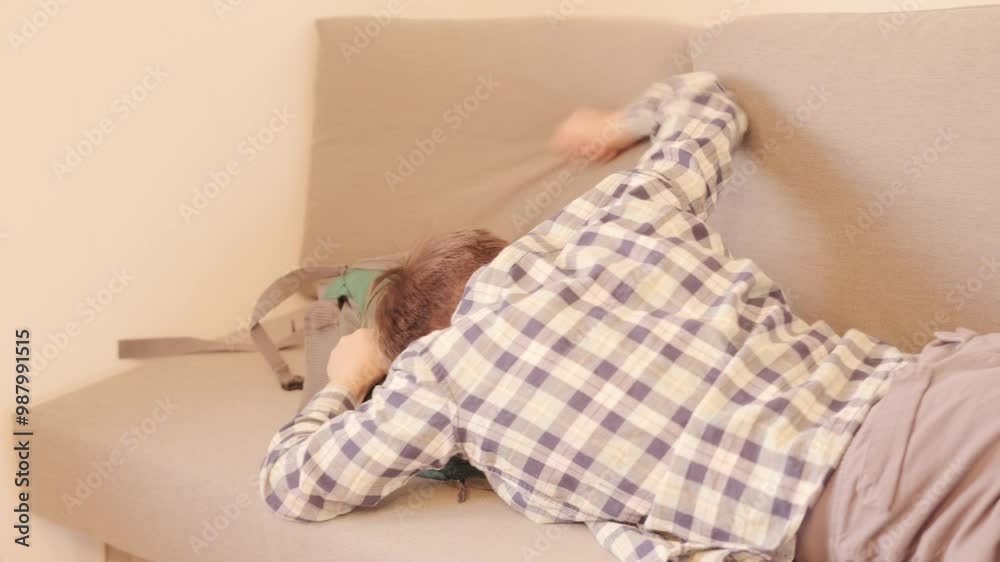 10-year-old boy in frustration, lying on sofa, punching pillows, experiencing teenage angst and tantrums, coping with emotions, angst and frustration, mental health 10-year-old boy in frustration, lying on sofa, punching pillows, experiencing teenage angst and tantrums, coping with emotions, angst and frustration, mental health