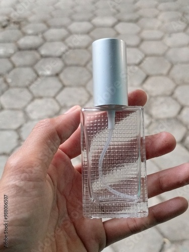 perfume with a glass bottle on the tile floor photo