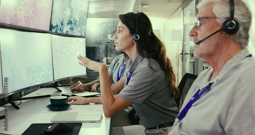 Team, control room and people monitor weather pattern on satellite maps to track storm. Meteorologist, climate scientist or group on screen for global warming, brainstorming or discussion on computer