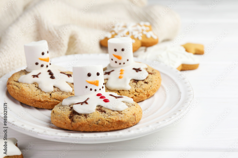 Delicious cookies with snowmen made of marshmallows on white table, closeup Delicious cookies with snowmen made of marshmallows on white table, closeup