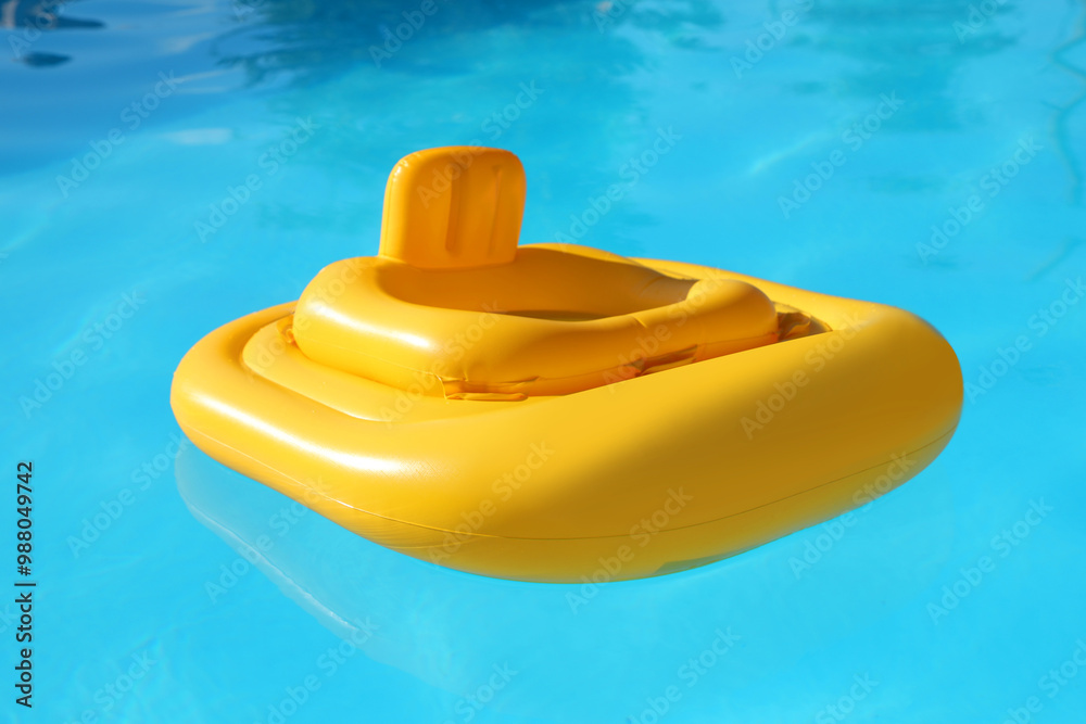 Yellow float in swimming pool at luxury resort Yellow float in swimming pool at luxury resort