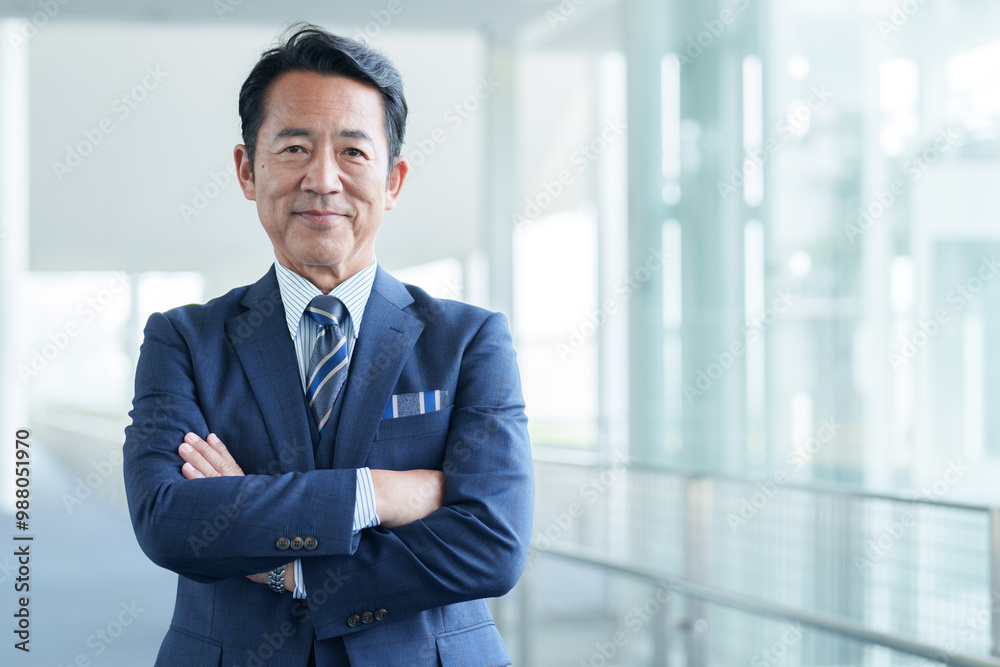 腕組みをする中高年のビジネスマン 腕組みをする中高年のビジネスマン