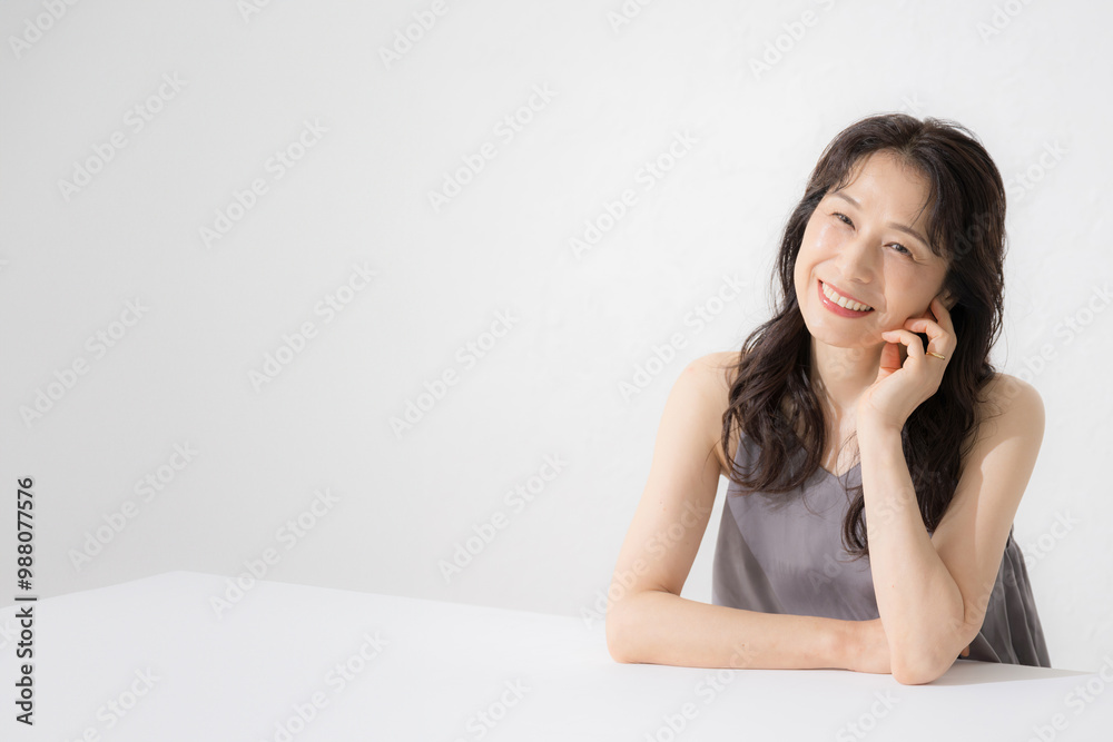 A beautiful 50-something woman with a cheeky smile for images such as beauty looking up thinking A beautiful 50-something woman with a cheeky smile for images such as beauty looking up thinking