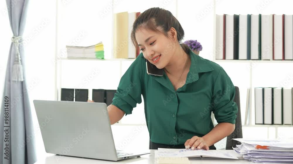 Asian businesswoman doing tax, accounting, statistics and analysis research using laptop computer and working in office with calculator on desk with documents, planning, analyzing financial report.