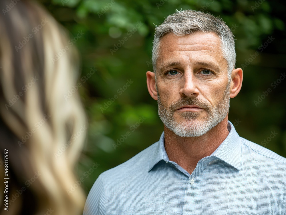 Serious mature man with gray hair and beard in natural setting Serious mature man with gray hair and beard in natural setting