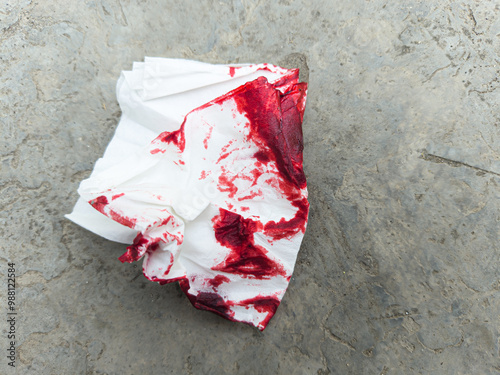 Crumpled bloody tissue paper on the ground concept murder, crime, accident, incident, emergency