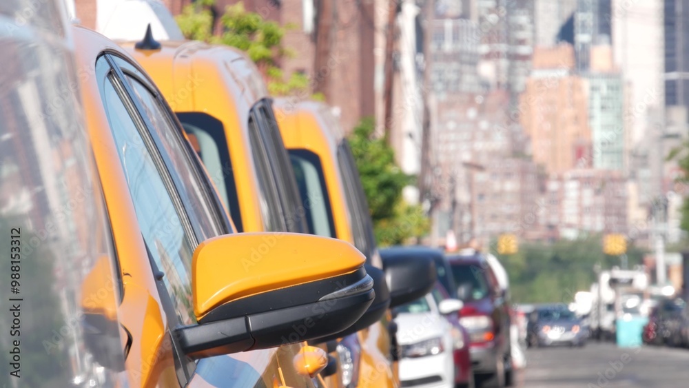 New York City. Row of yellow Taxi cars on street, Queens. Many taxi cabs on avenue, Long Island, LIC. Medallion taxicab and Manhattan Midtown urban skyline cityscape. High-rise building architecture. New York City. Row of yellow Taxi cars on street, Queens. Many taxi cabs on avenue, Long Island, LIC. Medallion taxicab and Manhattan Midtown urban skyline cityscape. High-rise building architecture.