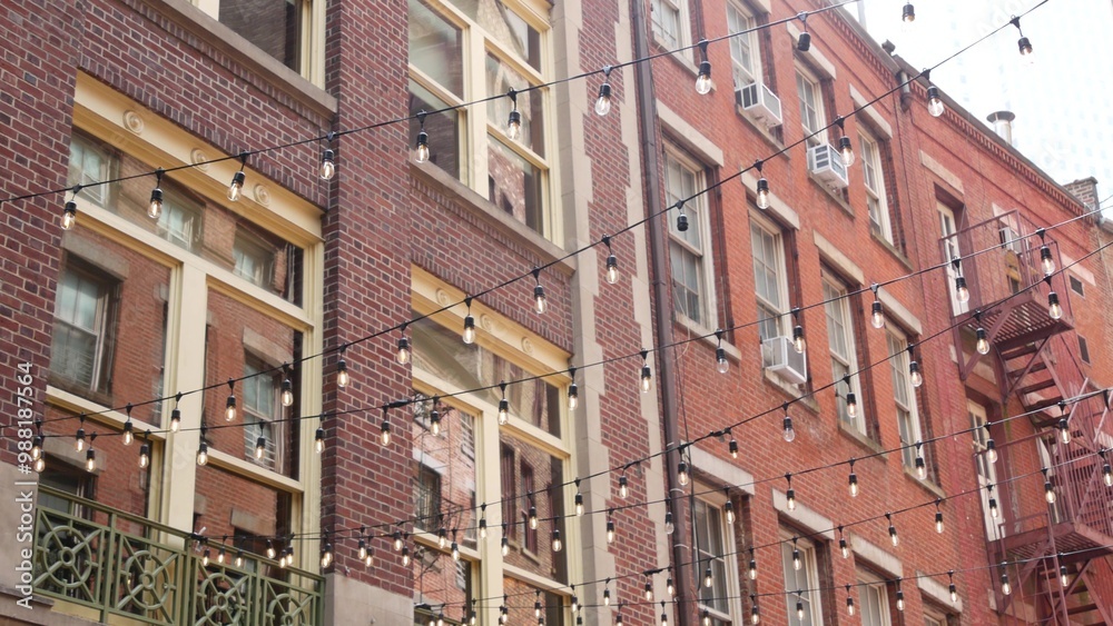 New York City classic building architecture. Residential house exterior. Real estate property in USA. Typical red brick facade. Manhattan downtown financial district, Stone street. Fire escape ladder. New York City classic building architecture. Residential house exterior. Real estate property in USA. Typical red brick facade. Manhattan downtown financial district, Stone street. Fire escape ladder.