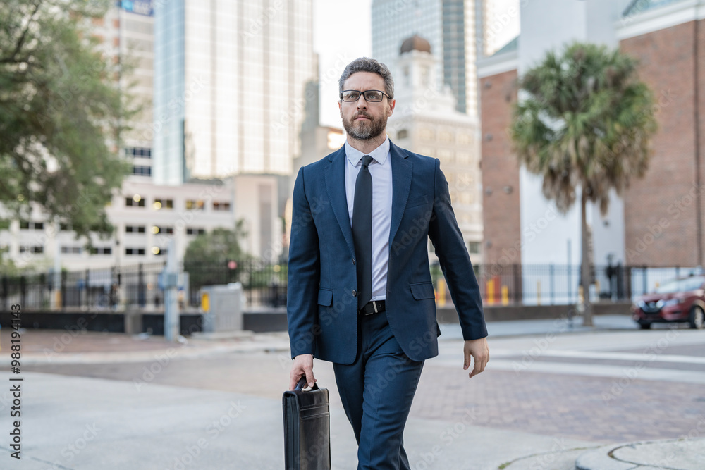 Businessman in suit walk outdoor. Walk to success. Businessman walk in the city. Business man crossing the street. Walk of business man. Businessman in New York. Business success Businessman in suit walk outdoor. Walk to success. Businessman walk in the city. Business man crossing the street. Walk of business man. Businessman in New York. Business success