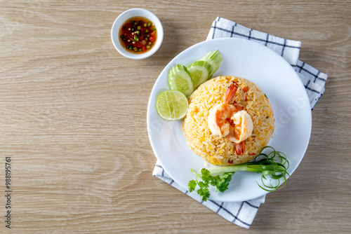 Shrimp fried ricei put in a white plate on the wooden table photo