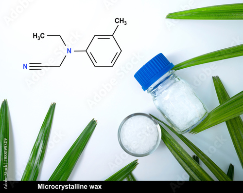 Microcrystalline wax with chemical formula on white laboratory table. Top view photo