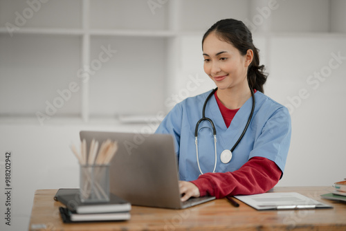 Young female doctor sitting and reading patient history