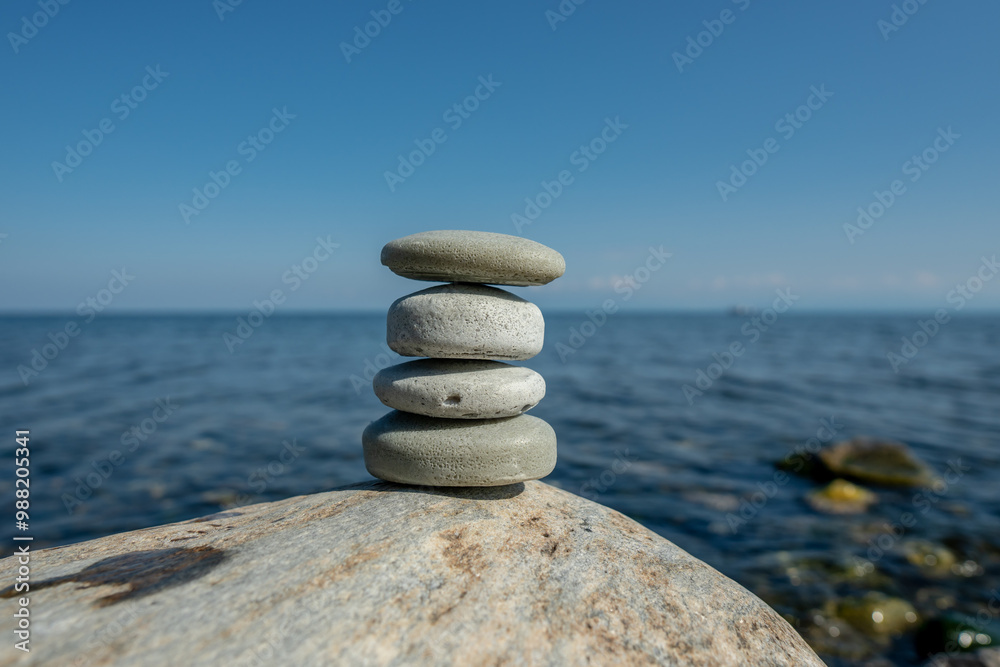 Pieces of craft soap in the shape of stones are stacked on top of each other against the background of the sea or lake. Image of organic cosmetics in a natural environment Pieces of craft soap in the shape of stones are stacked on top of each other against the background of the sea or lake. Image of organic cosmetics in a natural environment