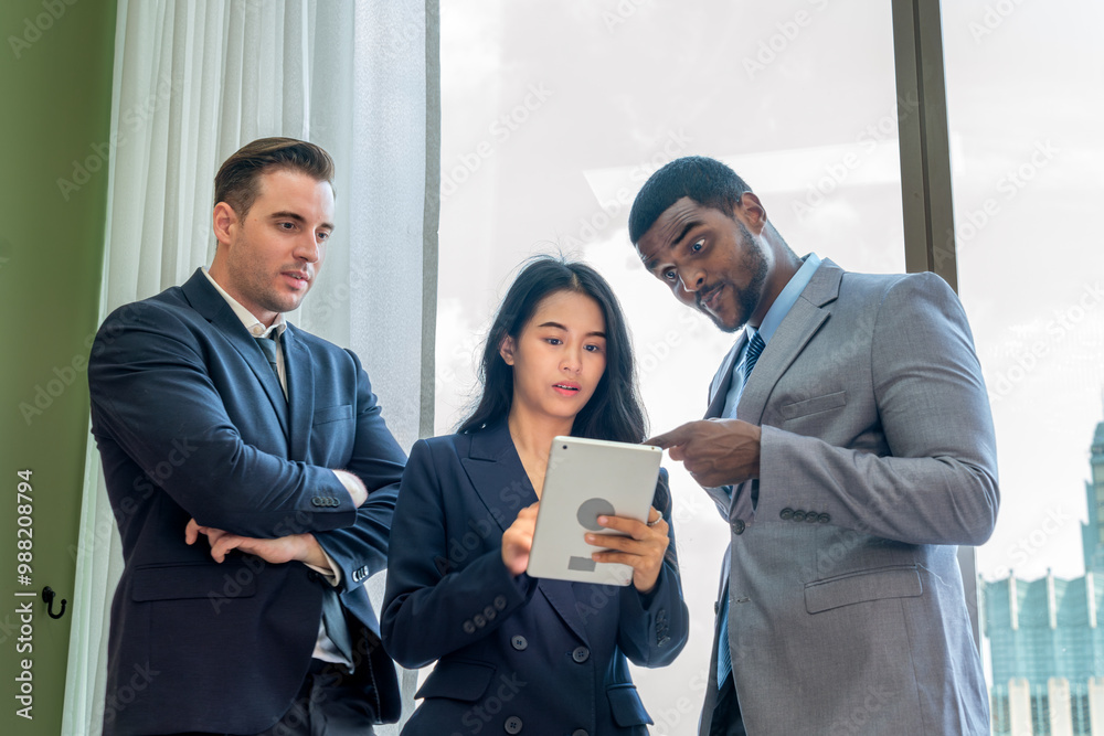 Multiracial Business Team Having a Discussion with Tablets in Modern Office Multiracial Business Team Having a Discussion with Tablets in Modern Office