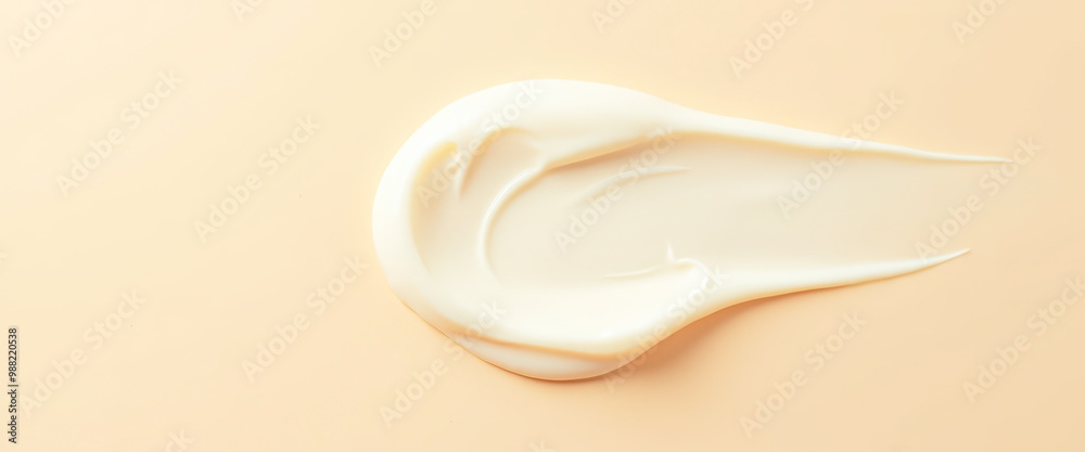 Creamy white skincare product on peach background Creamy white skincare product on peach background