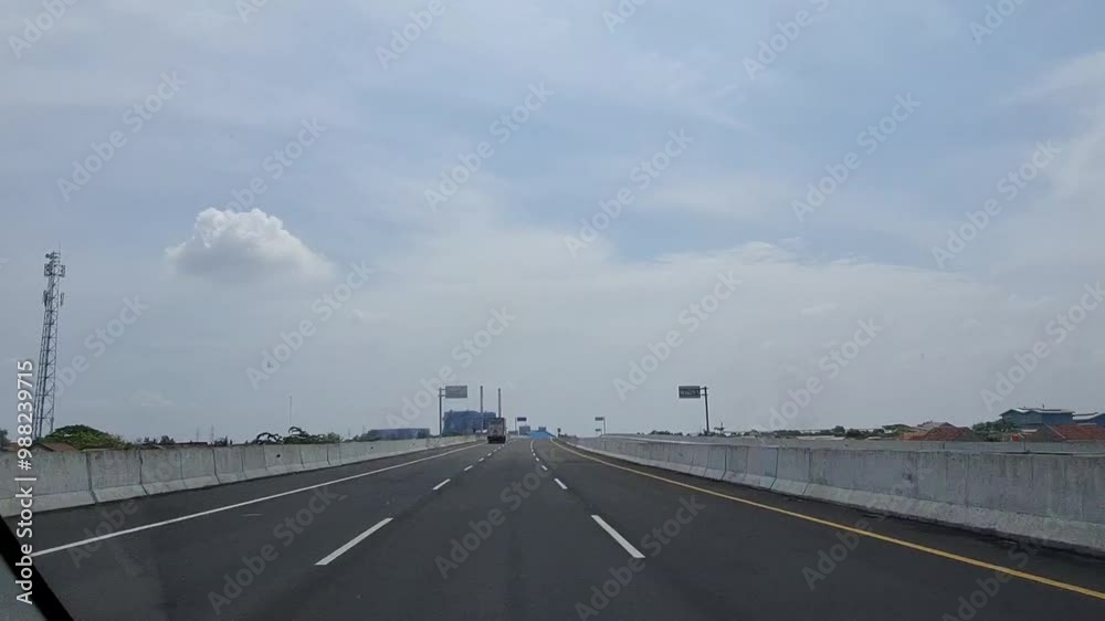 Bekasi, Indonesia on July 8 2023. Conditions on the Cibitung Cilincing toll road towards Bekasi where you can see from afar the Babelan Power Plant ow Bekasi, Indonesia on July 8 2023. Conditions on the Cibitung Cilincing toll road towards Bekasi where you can see from afar the Babelan Power Plant ow