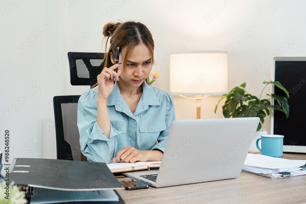 Business Woman Working from Home at Desk with Laptop, Lamp, and Office Supplies in Modern Home Office Setting Business Woman Working from Home at Desk with Laptop, Lamp, and Office Supplies in Modern Home Office Setting