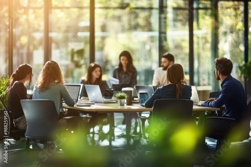 Group people sitting around table modern office space Blurred interior