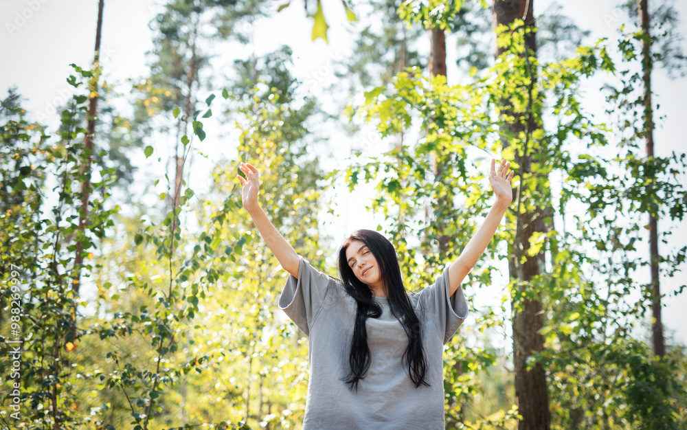 A young girl who breathes fresh air and relieves stress in the forest.