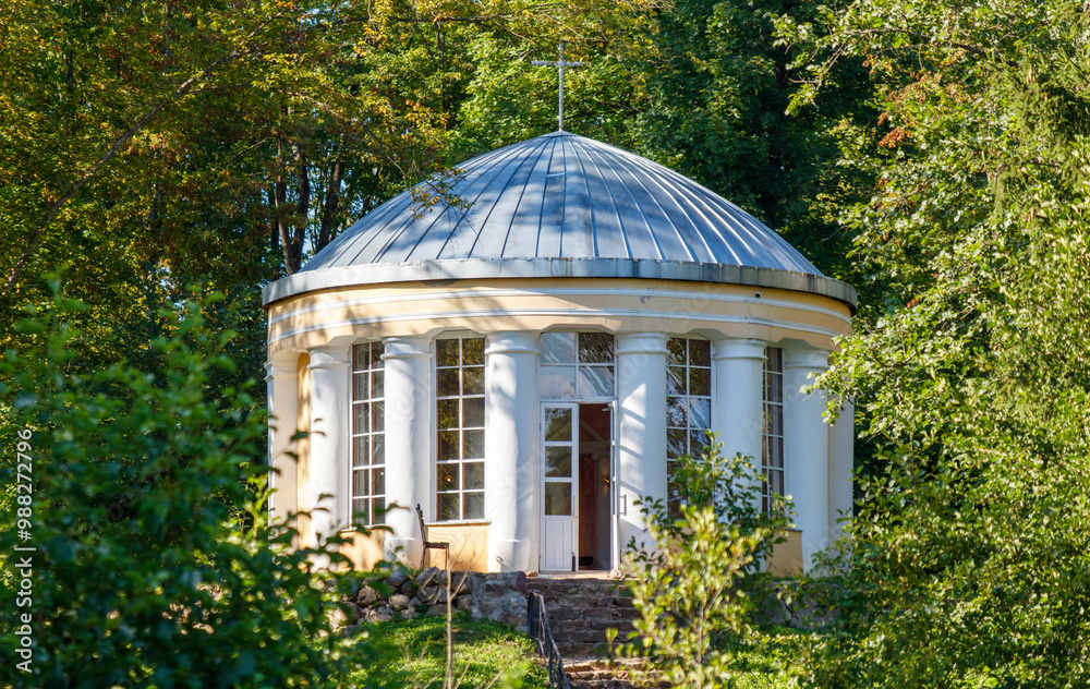 A small, white building with a dome on top A small, white building with a dome on top