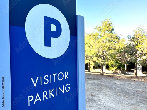 Visitor Parking lot sign near a garage structure.