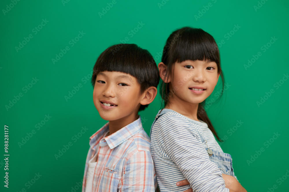 Brother, sister and children by chalkboard in portrait with smile for education, learning and development. Happy school kids, boy and girl with scholarship, study and progress at studio in Taiwan Brother, sister and children by chalkboard in portrait with smile for education, learning and development. Happy school kids, boy and girl with scholarship, study and progress at studio in Taiwan