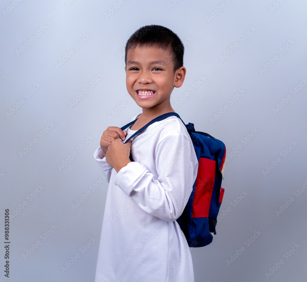 Asian cute boy wearing white and carry student backpack, Boy standing on white background, Lifestyle of a boy on a white background, He looks happy and content. Asian cute boy wearing white and carry student backpack, Boy standing on white background, Lifestyle of a boy on a white background, He looks happy and content.