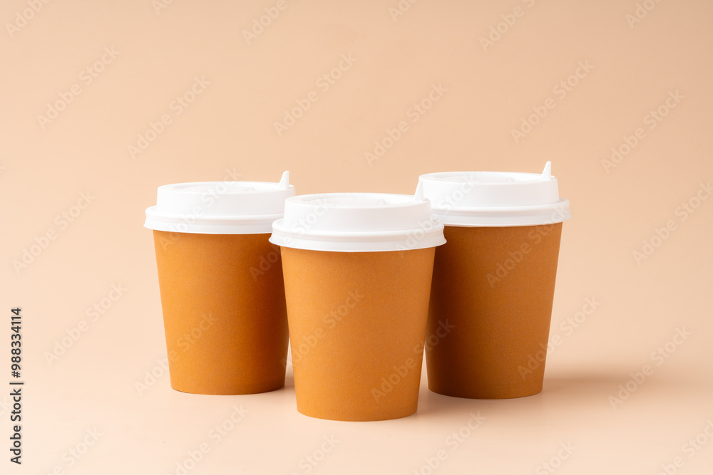 Paper cups stacked on a neutral background for a visually appealing display Paper cups stacked on a neutral background for a visually appealing display