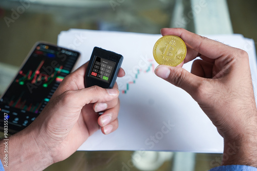 Indian man using bitcoin crypto currency hardware wallet to send funds for safety and protection. Risk management, Custodian.Block chain technology. Trading, investing and finance. photo