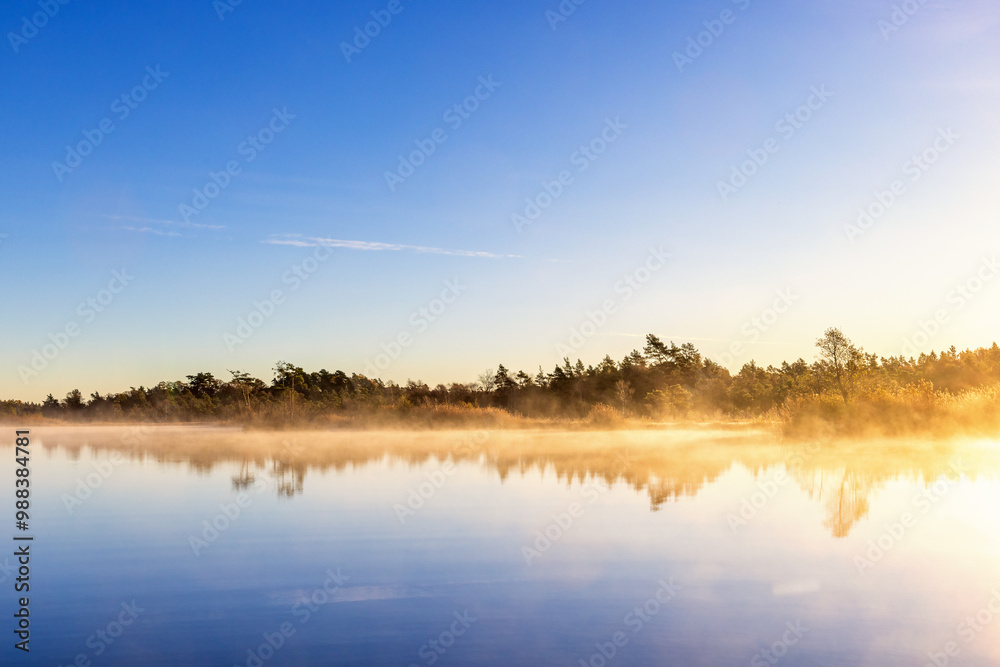 Sunrise with morning mist a forest lake in autumn Sunrise with morning mist a forest lake in autumn