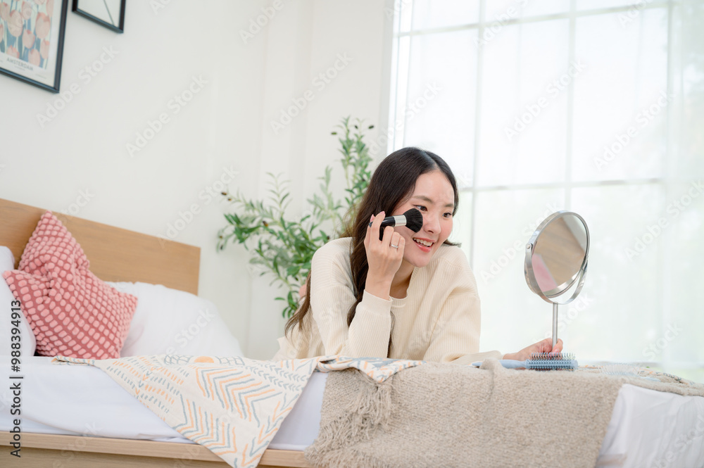 A beautiful girl is relaxing at home on her day off. She wakes up late, puts on makeup on the bed, and acts as lazily as possible. A beautiful girl is relaxing at home on her day off. She wakes up late, puts on makeup on the bed, and acts as lazily as possible.