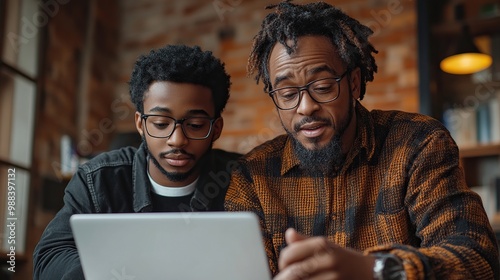 mature son helping father to manage his finance teaching how to work with internet baking, shopping online handsome son supporting dad technology, digital literacy