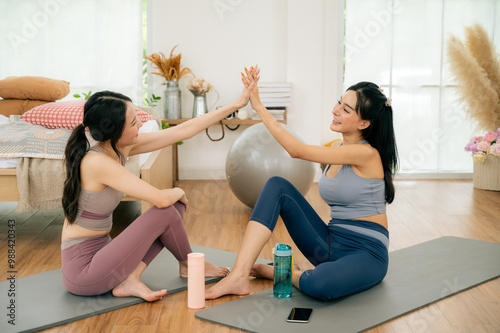 Asian girl doing yoga at home with her friends.concept health care and activity.