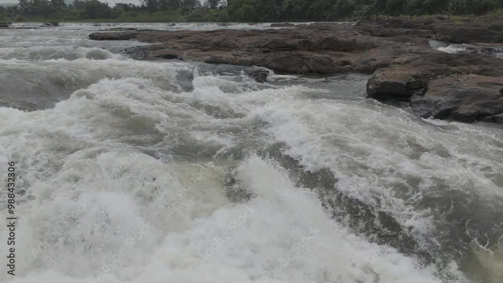 Aerial view of river flowing through the rock area. Raw footage of Beautiful nature river water and forest. D log M footage without color grad. Aerial view of river flowing through the rock area. Raw footage of Beautiful nature river water and forest. D log M footage without color grad.