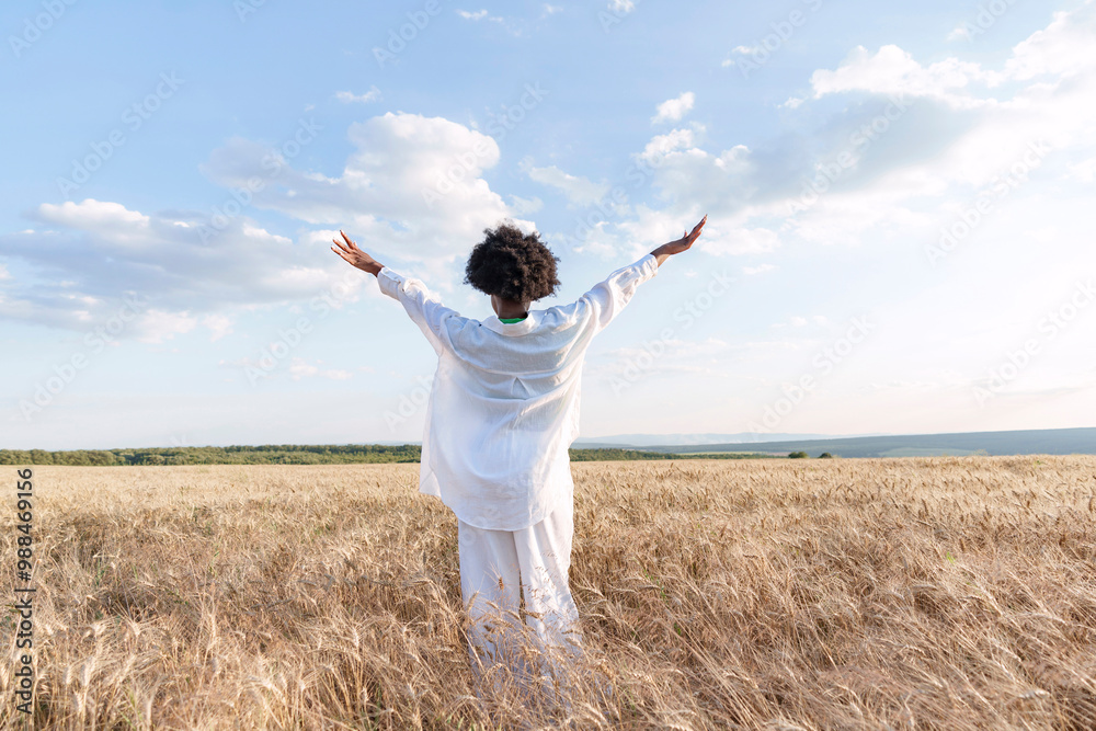 Young woman wearing white casuals standing amidst crops in field Young woman wearing white casuals standing amidst crops in field