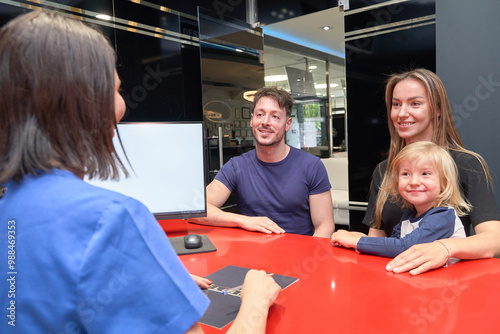 Canvas Print family in a dentist's office receiving an estimate for dental treatment