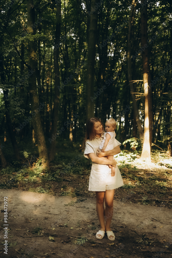 A mother and daughter walking in the forest A mother and daughter walking in the forest